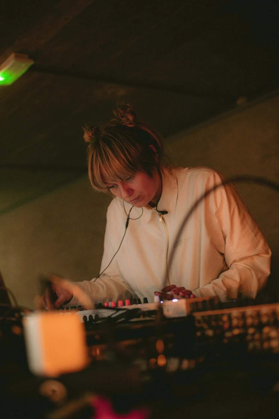 Nadia performing with hardware in warm light at ZERØBPM during ADE 2026